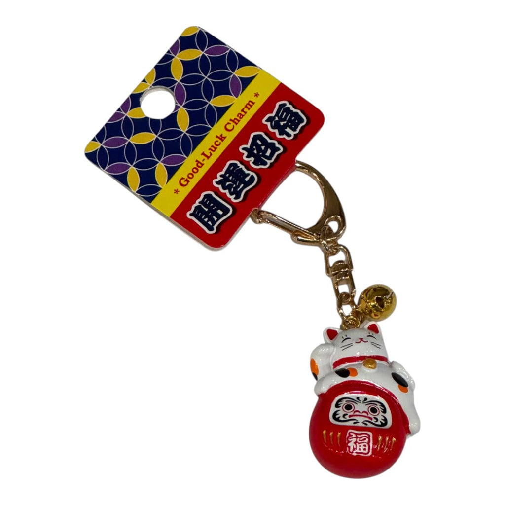 Twinkle Glory Japanese lucky cat and red Daruma doll bag charm keyring with gold bell detail on display card