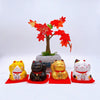 Twinkle Glory set of four Yakushigama mini lucky cats in yellow, black, gold, and calico on red mats with maple tree