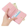 Twinkle Glory Sanrio My Melody pastel pink bifold wallet with gold clasp closure and card slots held in a hand