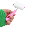 Twinkle Glory My Melody sticky roller cleaner with a pink handle and white adhesive tape held in a hand