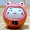 Twinkle Glory small pink porcelain Daruma lucky cat figurine with hand-painted details and a smiling face