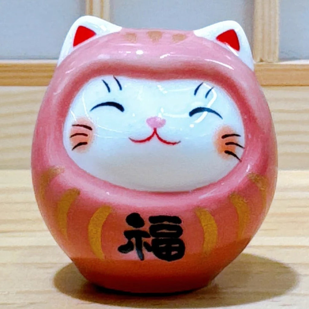 Twinkle Glory small pink porcelain Daruma lucky cat figurine with hand-painted details and a smiling face