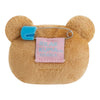 Twinkle Glory San-X Rilakkuma plush badge back view showing the blue safety pin and branded fabric tag