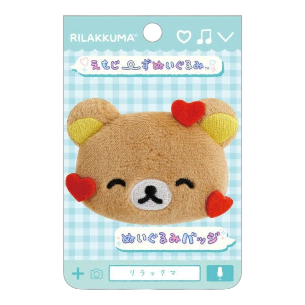Twinkle Glory San-X Rilakkuma plush badge featuring a brown bear face with red heart accents on a display card