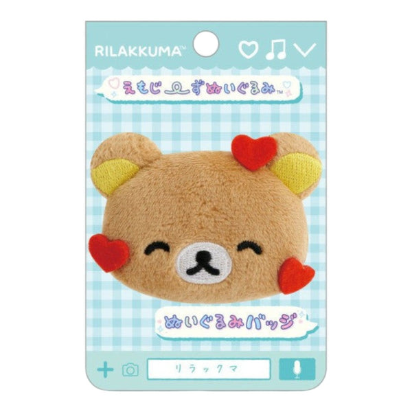 Twinkle Glory San-X Rilakkuma plush badge featuring a brown bear face with red heart accents on a display card
