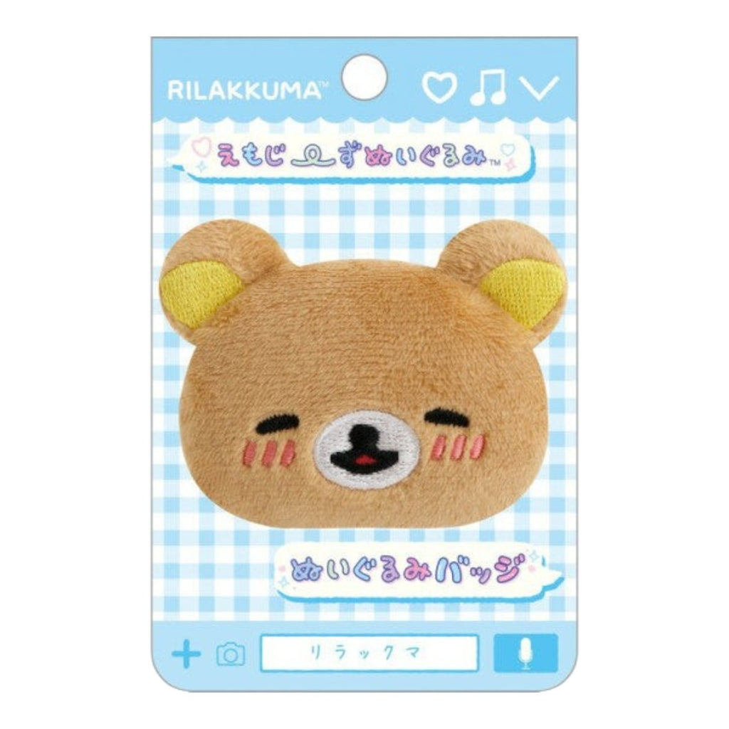 Twinkle Glory San-X Rilakkuma plush badge featuring a smiling brown bear face with pink blushing cheeks