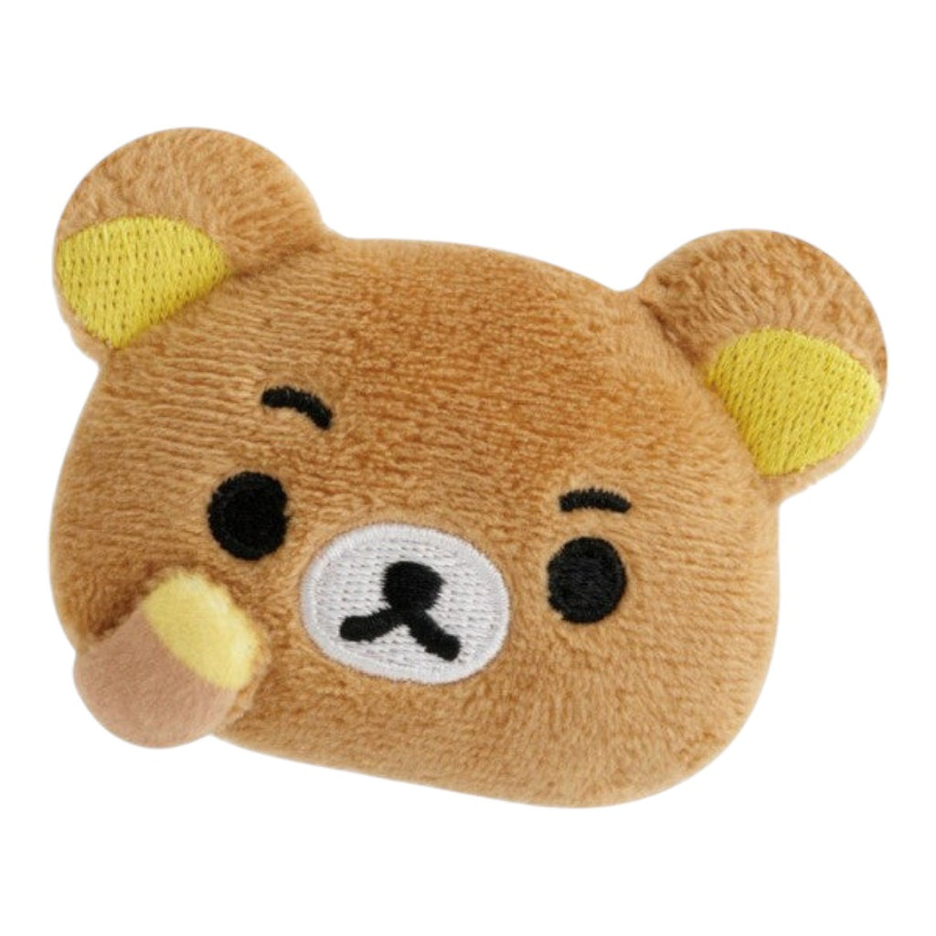 Twinkle Glory San-X Rilakkuma plush badge featuring a brown bear with a puzzled expression and yellow ear details.