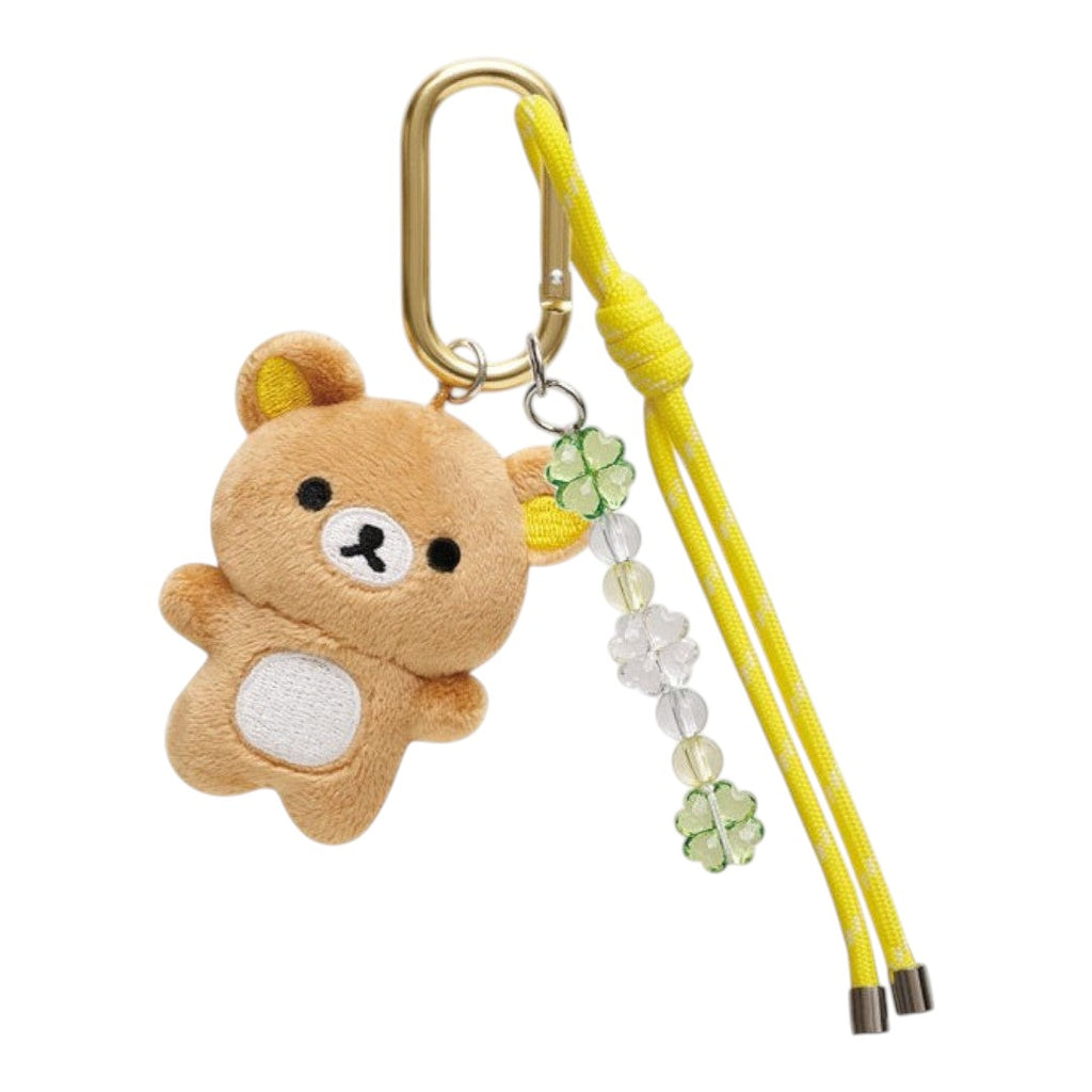 Twinkle Glory San-X Rilakkuma plush keychain with a gold carabiner, yellow cord, and decorative clover beads.
