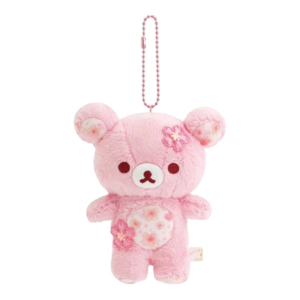 Twinkle Glory Rilakkuma plush keychain in soft pink with cherry blossom flower accents and a metal ball chain.