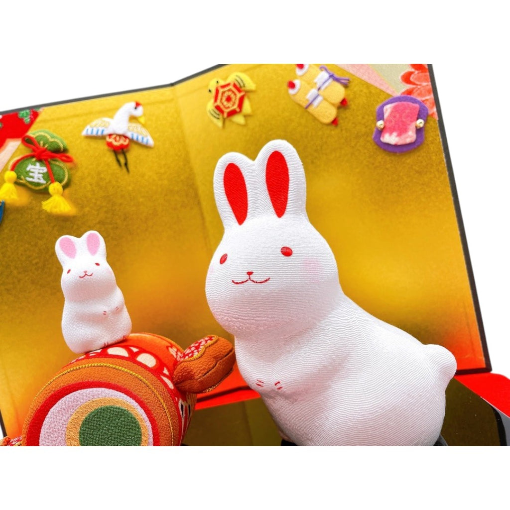 Twinkle Glory Ryukodo ceramic zodiac rabbit figurines with a lucky gavel and decorative gold folding screen background.
