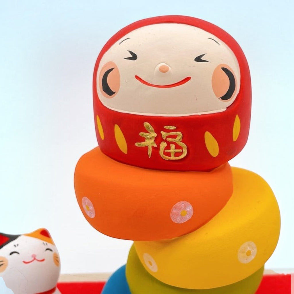 Twinkle Glory Ryukodo porcelain Daruma Otoshi stacking game with a hand-painted red Daruma head and colorful base