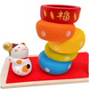 Twinkle Glory Ryukodo porcelain Maneki Neko lucky cat figurine with a colorful stacked Daruma Otoshi game on red cloth