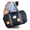 Twinkle Glory San-X Sumikko Gurashi Tokage plush badge attached to a navy blue school bag