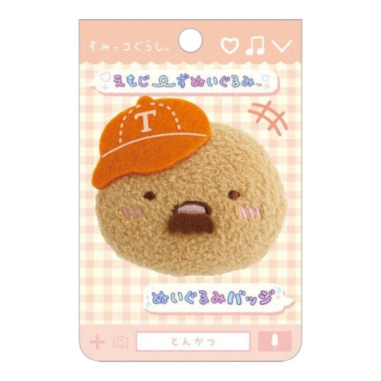 Twinkle Glory San-X Sumikko Gurashi Tonkatsu plush badge with an orange cap and beard on a branded display card
