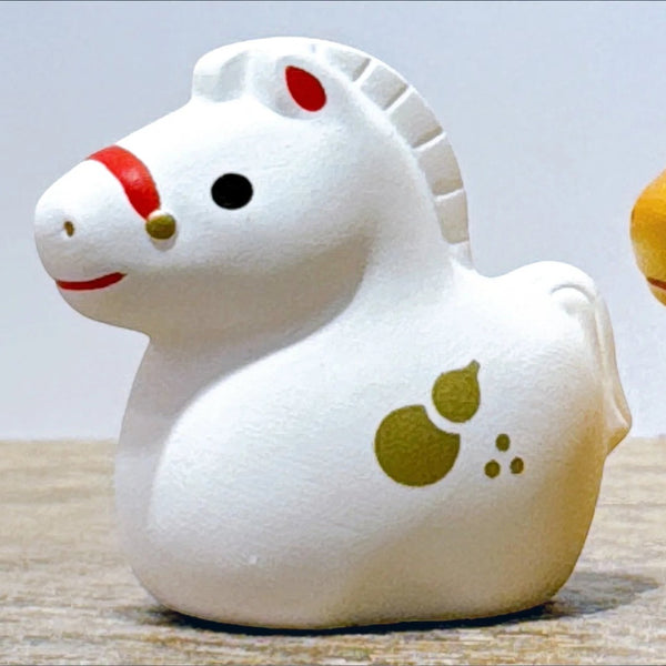 Twinkle Glory white ceramic horse zodiac figurine with red and gold accents and a gourd motif