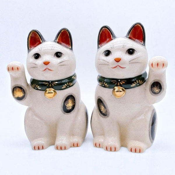 Twinkle Glory Yakushigama ceramic lucky cat pair with green chrysanthemum collars and golden bells on white background