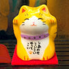 Twinkle Glory Japanese yellow Maneki Neko lucky cat figurine with purple collar and Japanese calligraphy on chest