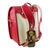 Twinkle Glory Demon Slayer Zenitsu PVC polyester key case with retractable reel attached to a red and cream backpack