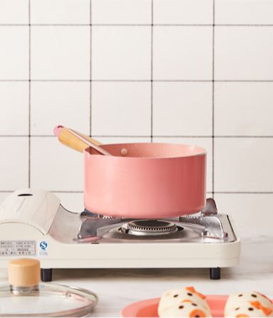 Pink Pastel Stove Top Pot on a gas stove