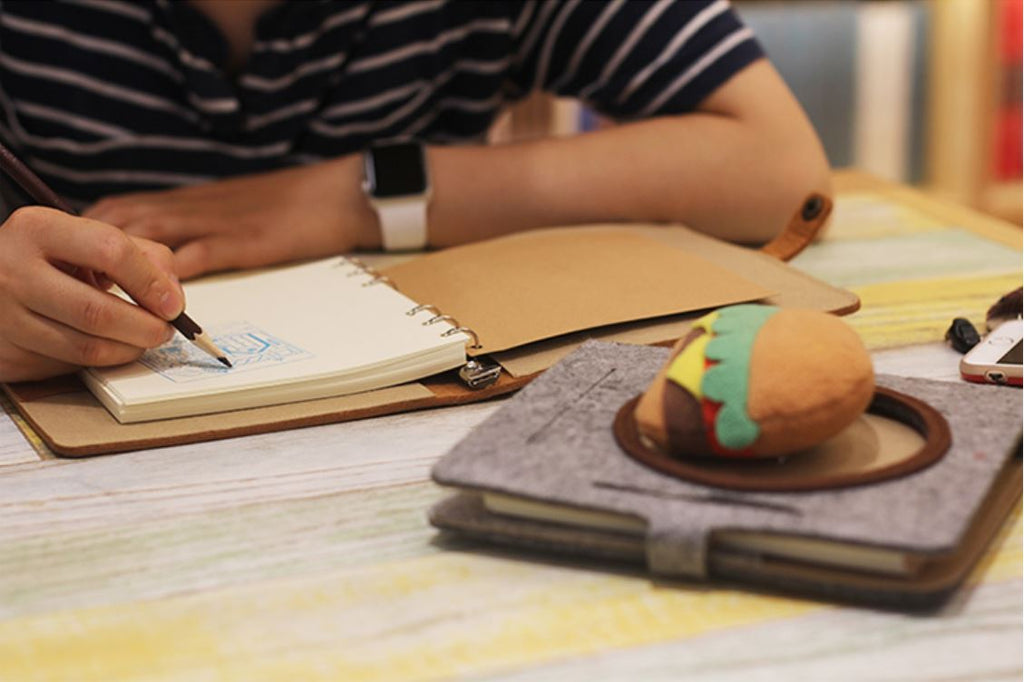 A person drawing in a Cartoon 3D Diary Notebook