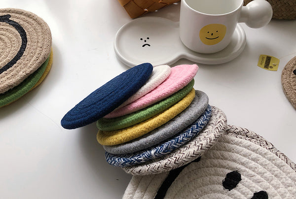A stack of differently coloured Smiley Face mat coasters