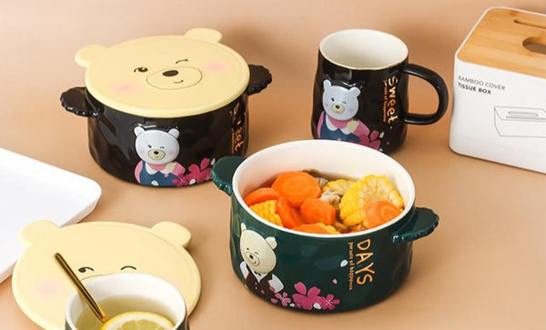 Green and black Cartoon Bear Ceramic Bowls next to each other