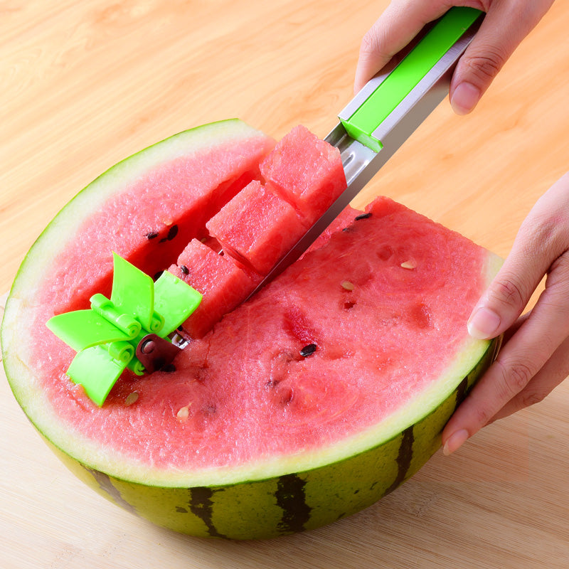 A stainless steel watermelon cutter cutting watermelon cubes out of a watermelon